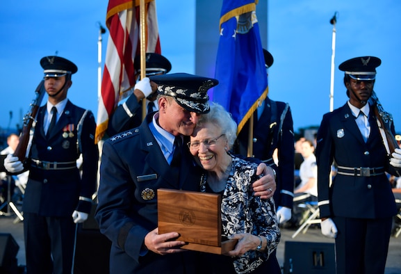 Chief of Staff of the Air Force Gen. David L. Goldfein presents Mrs. Doris Day the brigadier general rank of her deceased husband, retired Col. George E. "Bud" Day,  during the 2018 Heritage to Horizons summer concert in Arlington, Va., June 8, 2018. The stars were originally Goldfein's when he was a brigadier general. (U.S. Air Force photo by Wayne A. Clark)