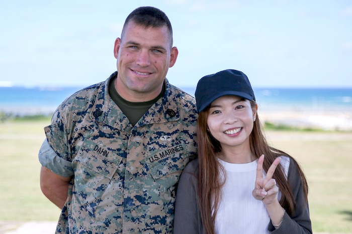 A Marine poses next to a woman.