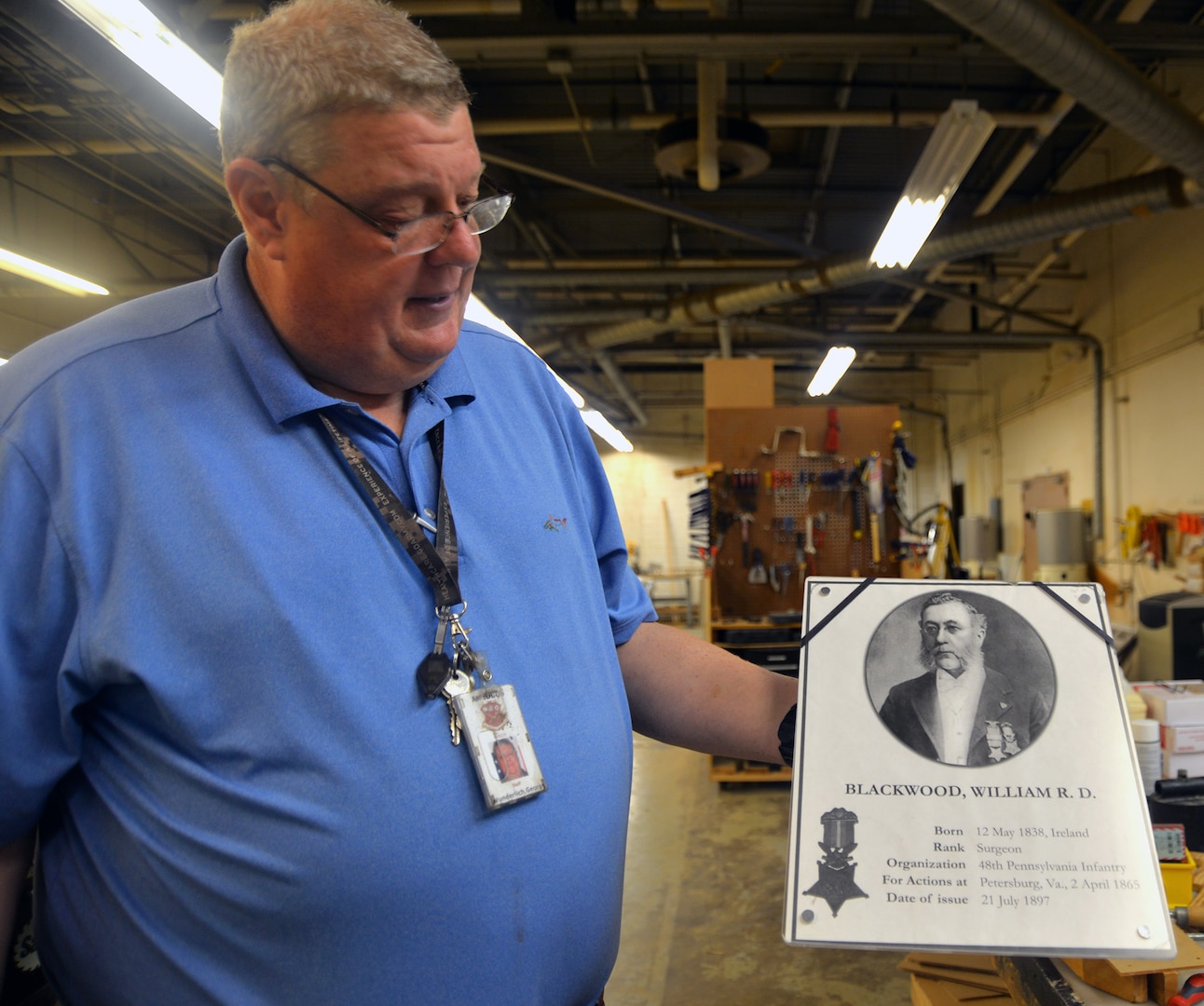 George Wunderlich, U.S. Army Medical Department Museum director, holds a model of a photo and text that will be placed in a new exhibit at the museum dedicated to the 52 Medal of Honor recipients who served in the U.S. Army Medical Department. Wunderlich is hoping the new exhibit, which will be placed in the main hallway and foyer of the AMEDD Museum, will ready be for public viewing by June 15.