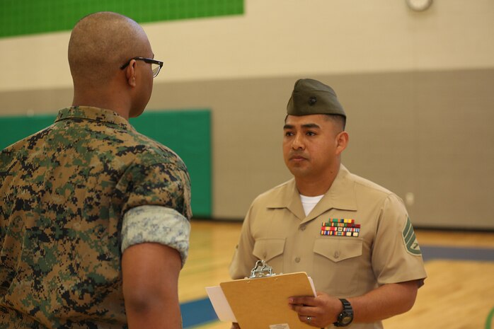 Marines and Sailors with Chemical Biological Incident Response Force, U.S. Marine Corps Forces Command, volunteered their time to conduct a JROTC uniform inspection at St. Charles High School in Waldorf, Md., April 18, 2018. During the inspection the Marines and sailors looked over the students’ uniforms, tested their military knowledge and shared their expertise with the high school students. (Official USMC Photos by Staff Sgt. Santiago G. Colon Jr.)