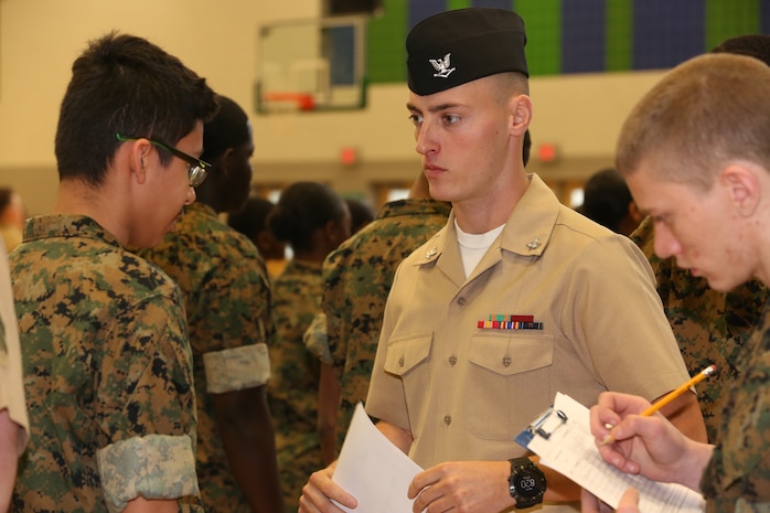 Marines and Sailors with Chemical Biological Incident Response Force, U.S. Marine Corps Forces Command, volunteered their time to conduct a JROTC uniform inspection at St. Charles High School in Waldorf, Md., April 18, 2018. During the inspection the Marines and sailors looked over the students’ uniforms, tested their military knowledge and shared their expertise with the high school students. (Official USMC Photos by Staff Sgt. Santiago G. Colon Jr.)