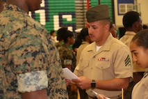 Marines and Sailors with Chemical Biological Incident Response Force, U.S. Marine Corps Forces Command, volunteered their time to conduct a JROTC uniform inspection at St. Charles High School in Waldorf, Md., April 18, 2018. During the inspection the Marines and sailors looked over the students’ uniforms, tested their military knowledge and shared their expertise with the high school students. (Official USMC Photos by Staff Sgt. Santiago G. Colon Jr.)