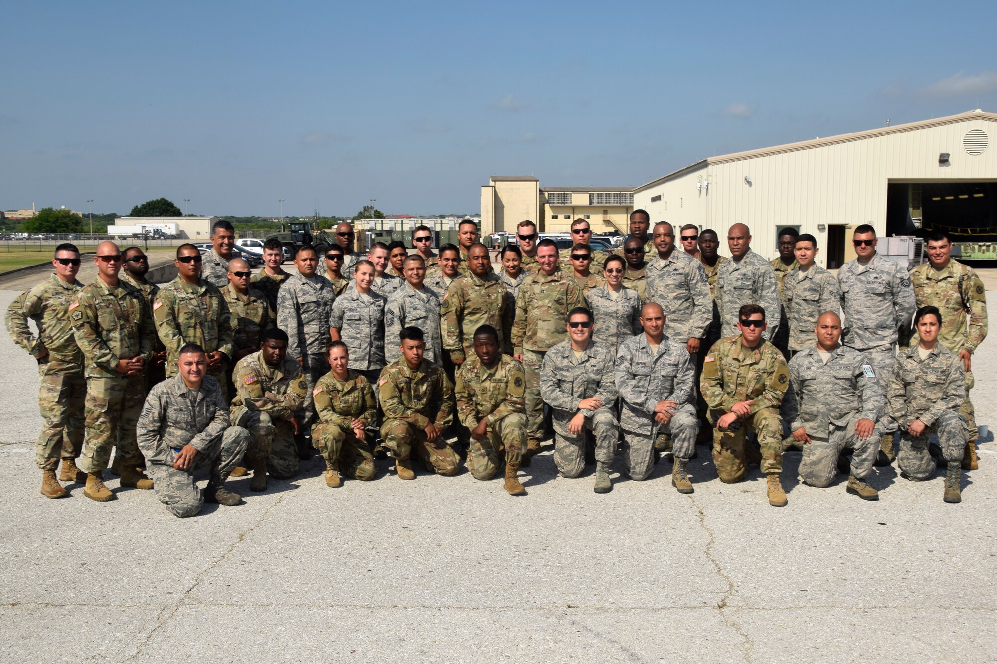 U.S. Air Force Reserves Command Chief Master Sgt. Ericka E. Kelly and Fourth Air Force Command Chief Master Sgt. Timothy C. White Jr. pose with members of the 74th Aerial Port Squadron and 61st Quartermaster Battalion at the Cargo Load Training facility June 2, 2018, at Joint Base San Antonio-Lackland, Texas. The command chiefs visited with members of the 433rd Airlift Wing during their visit in the area. (U.S. Air Force photo by Staff Sgt. Lauren M. Snyder)