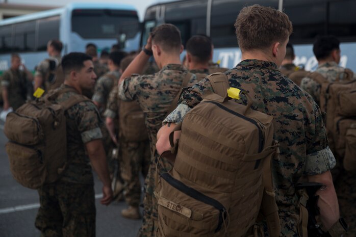 Marines with Battalion Landing Team, 2nd Battalion, 5th Marines, load onto busses headed to Camp Hansen, Okinawa, Japan, May 18, 2018.