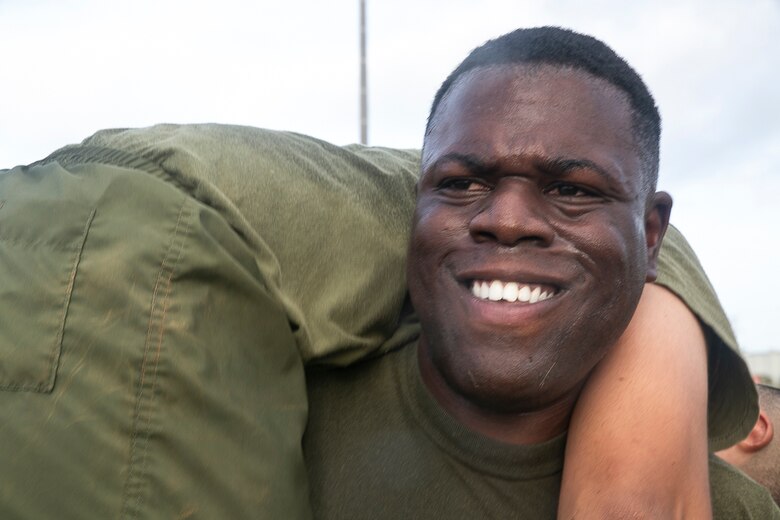 Sergeant Wayne Hill, a motor transportation mechanic with the 31st Marine Expeditionary Unit, performs a buddy-squat during a Force Fitness Instructor led High Intensity Tactical Training session at Camp Hansen, Okinawa, Japan, June 8, 2018.