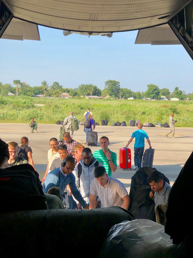 U.S. service members unload medical, engineering and multimedia support equipment from a 910th Air Wing C-130H Hercules at Suai Airport, June 6, 2018.