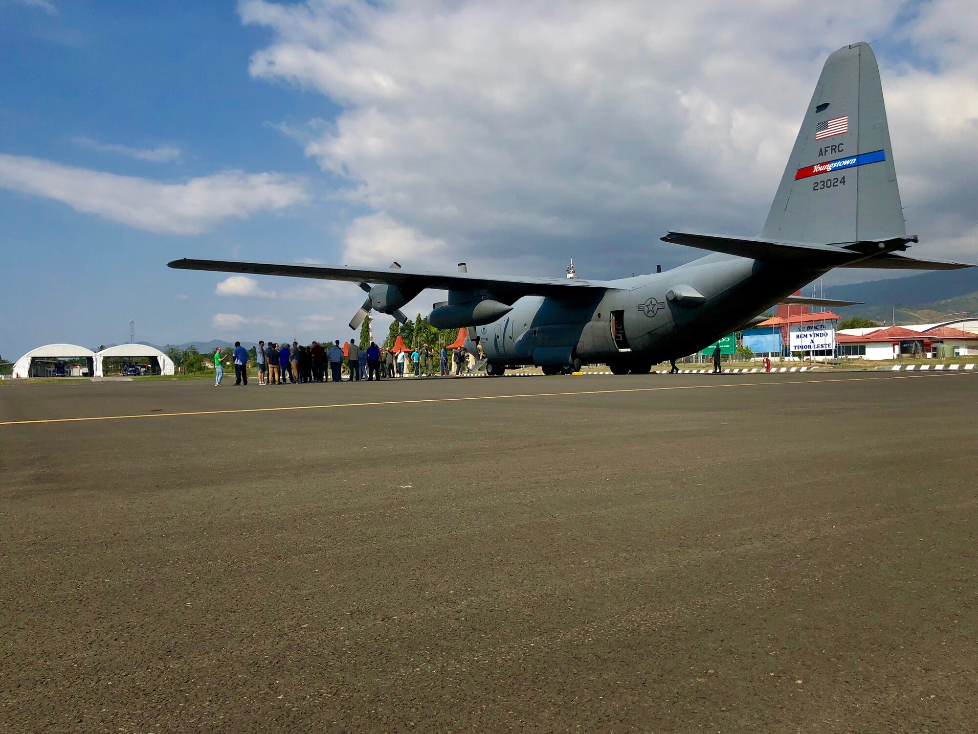 A 910th Air Wing C-130H Hercules from Youngstown, Ohio, flying more than 40 U.S. service members, equipment and supplies from Anderson Air Force Base, Guam, to Suai, Timor-Leste for Pacific Angel 18-1, sits on the flight line at Dili International Airport, June 6, 2018.