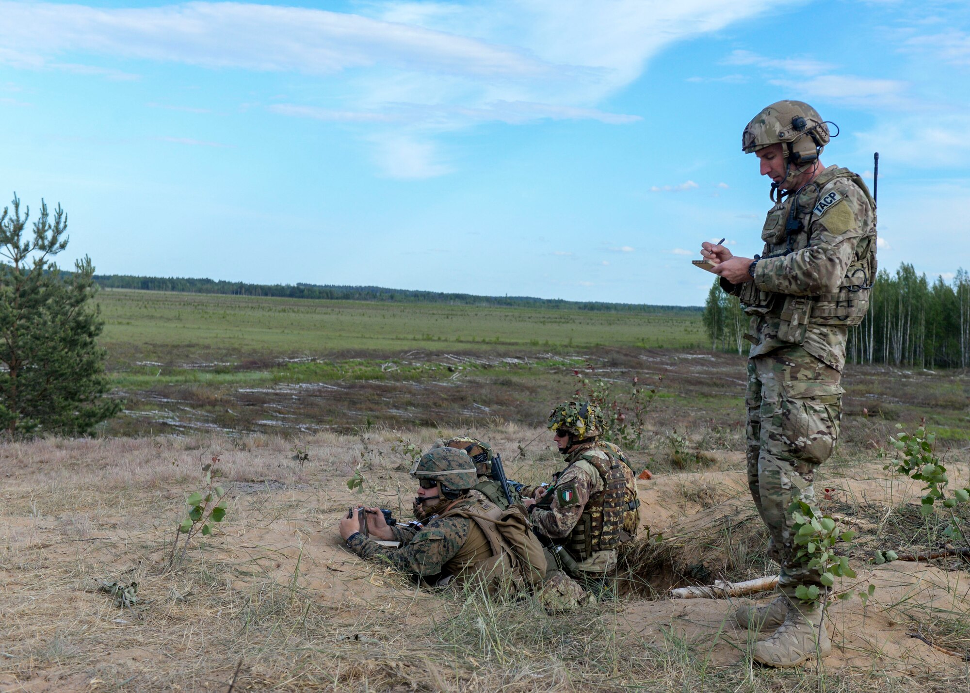 U.S. Air Force Senior Master Sgt. Perry Jackson, right, 122nd Air Support Operations Squadron superintendent, takes notes as an observer controller in Adazi, Latvia on June 7, 2018. Observer controllers help control scenarios for other controllers to work through during exercises and assist the Range Control Officer with safety. (U.S. Air Force photo by Staff Sgt. Jimmie D. Pike)