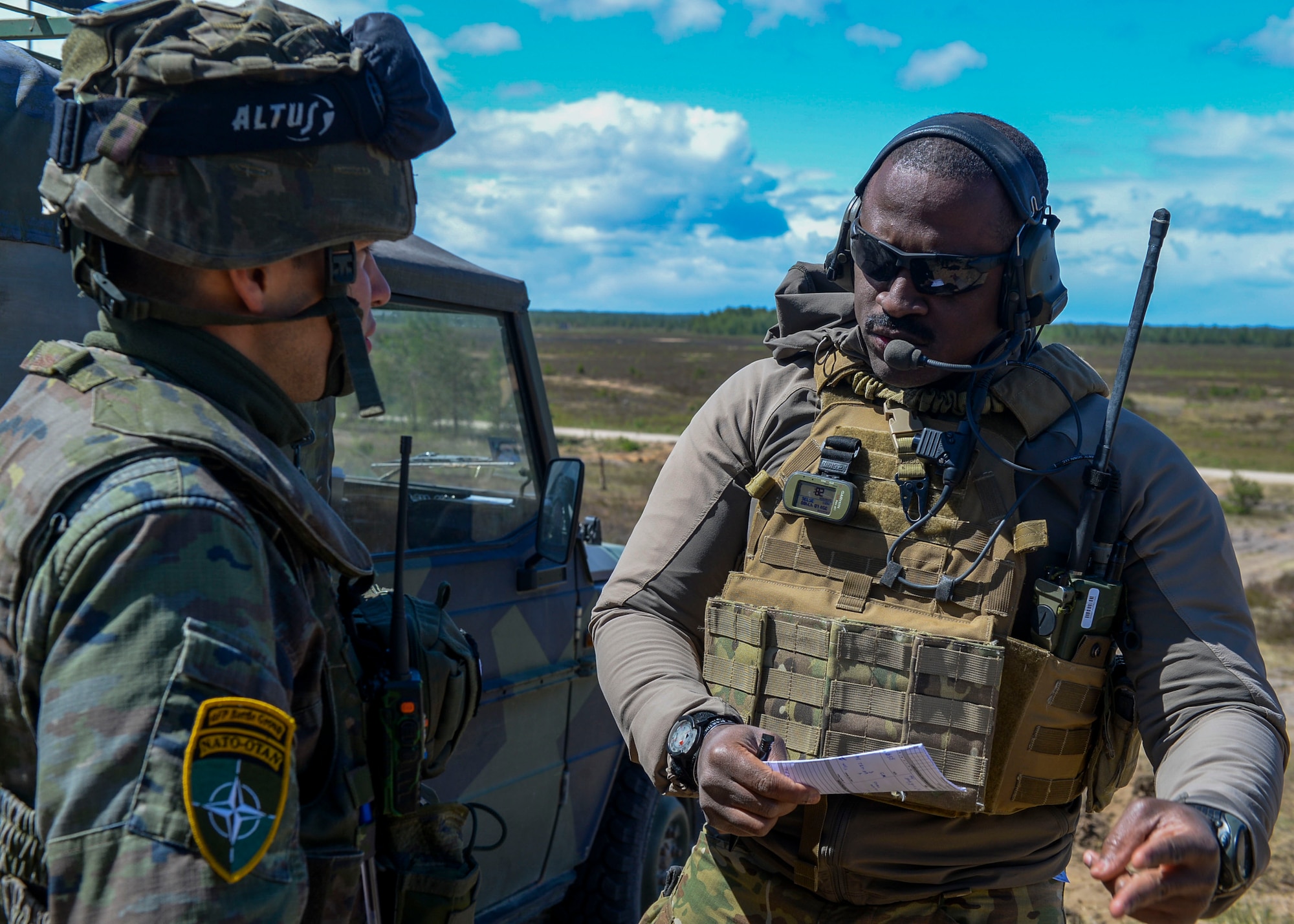 U.S. Air Force Tech. Sgt. Louis Awua, 122nd Air Support Operations Squadron Joint Terminal Attack Controller instructor, explains procedures for calling in close air support to OF-1 Ricardo Cobos, Spanish Forces JTAC, during Saber Strike 18 in Adazi, Latvia, June 5, 2018. During Saber Strike 18, approximately 18,000 members from 19 countries worked together to build on interoperability to improve air, land, and sea capabilities. (U.S. Air Force photo by Staff Sgt. Jimmie D. Pike)