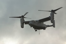 An MV-22 Osprey prepares to land during external lift training at Landing Zone Dodo, Camp Hansen, Okinawa, Japan, June 6, 2018. Landing support specialist Marines with Air Delivery Platoon, 3rd Transportation Support Battalion, 3rd Marine Logistics Group, conducted this training to refine their helicopter support skills. The Osprey is a heavy-lift helicopter capable of transporting 15,000 pounds of external cargo. (U.S. Marine Corps photo by Lance Cpl. Zackary M. Walker)