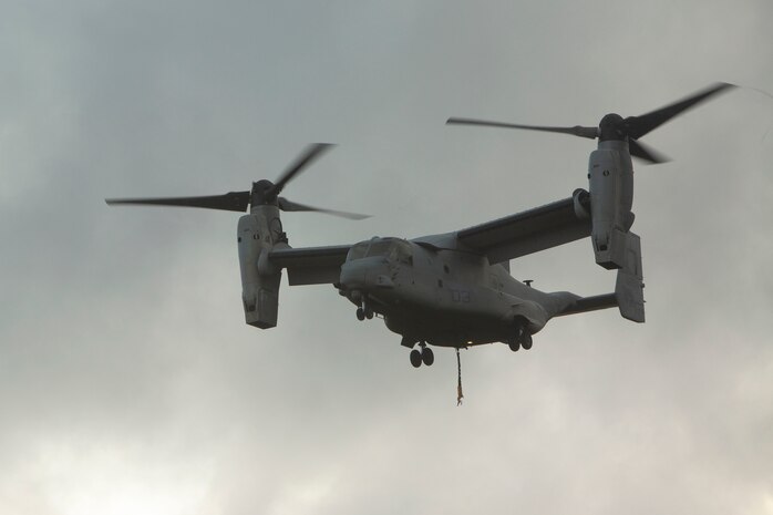 An MV-22 Osprey prepares to land during external lift training at Landing Zone Dodo, Camp Hansen, Okinawa, Japan, June 6, 2018. Landing support specialist Marines with Air Delivery Platoon, 3rd Transportation Support Battalion, 3rd Marine Logistics Group, conducted this training to refine their helicopter support skills. The Osprey is a heavy-lift helicopter capable of transporting 15,000 pounds of external cargo. (U.S. Marine Corps photo by Lance Cpl. Zackary M. Walker)