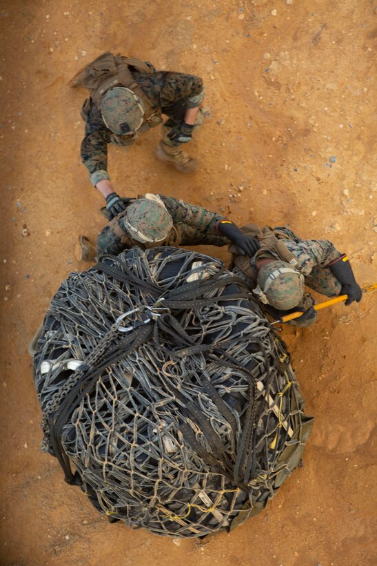 Landing support specialist Marines with Air Delivery Platoon, 3rd Transportation Support Battalion, 3rd Marine Logistics Group standby to secure a load of tires to an MV-22 Osprey during external lift training June 6, 2018 at Landing Zone Dodo, Camp Hansen, Okinawa, Japan. This training is designed to enhance the Marines’ techniques and procedures when securing cargo for external and internal lifts. (U.S. Marine Corps photo by Lance Cpl. Zackary M. Walker)