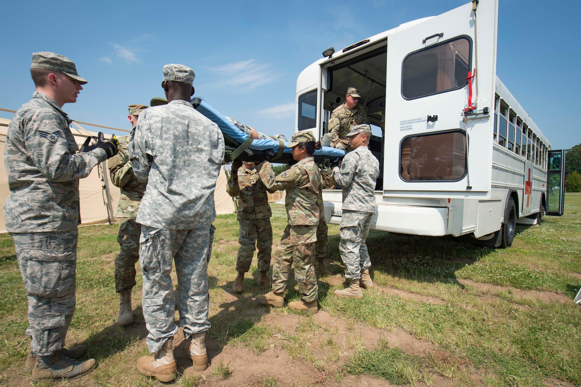 The 86th Medical Group, 345th Field Hospital, and 411th Hospital Center practice unloading a simulated patient from an ambulance during the 86th MDG's exercise Maroon Surge Community Outreach Day on Ramstein Air Base, Germany, June 7, 2018. Croatian Armed Forces members and 10 distinguished visitors from across the Kaiserslautern Military Community came to learn about the U.S. Air Force and Army medical capabilities. (U.S. Air Force photo by Senior Airman Elizabeth Baker)