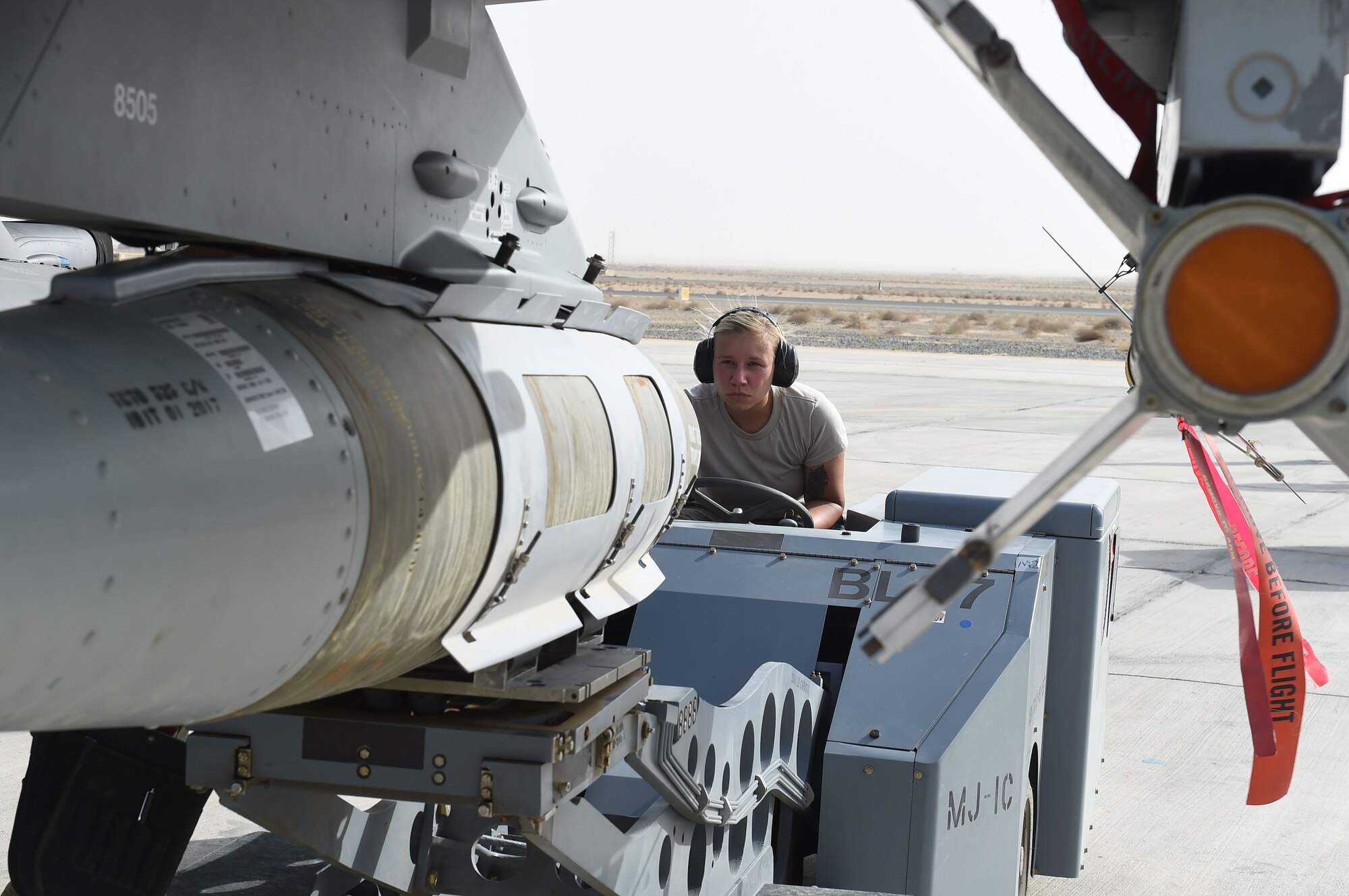 Female Airman drives vehicle to attach bomb to plane