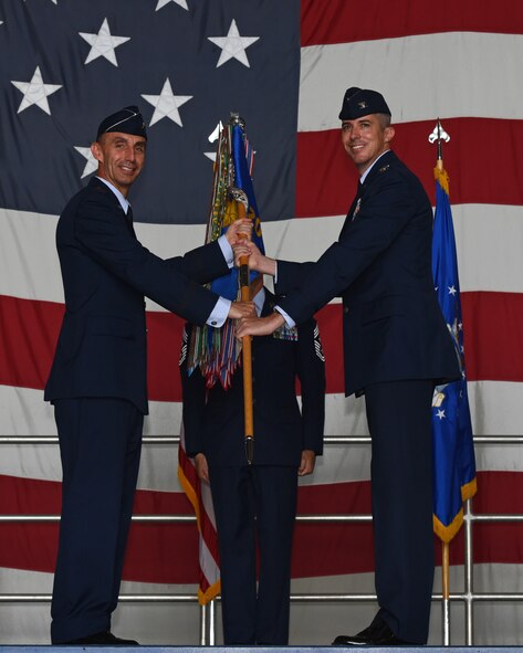 U.S. Air Force Maj. Gen. Scott J. Zobrist, 9th Air Force commander, left, gives the 20th Fighter Wing (FW) guidon to Col. Derek O’Malley, 20th FW commander, during a change of command ceremony at Shaw Air Force Base, S.C., June, 8, 2018.