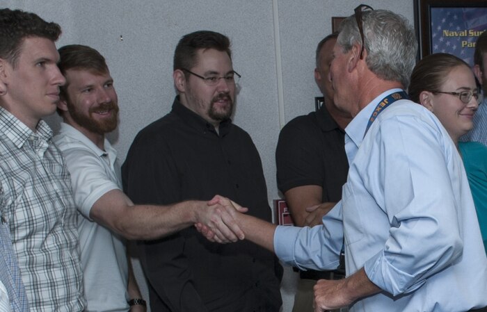 Naval Surface Warfare Center Panama City Division Amphibious and Expeditionary Maneuver Systems Deputy Department Head Carl Walters, right, shakes hands and welcomes new employees after they took the Oath of Office. The newly hired employees were part of a ceremony held in the NSWC PCD headquarter building June 11, 2018 in Panama City, Florida. (RELEASED). U.S. Navy photo by Eddie Green, NSWC PCD.