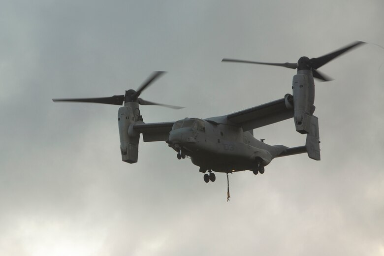 An MV-22 Osprey prepares to land during external lift training at Landing Zone Dodo, Camp Hansen, Okinawa, Japan, June 6, 2018. Landing support specialist Marines with Air Delivery Platoon, 3rd Transportation Support Battalion, 3rd Marine Logistics Group, conducted this training to refine their helicopter support skills. The Osprey is a heavy-lift helicopter capable of transporting 15,000 pounds of external cargo.