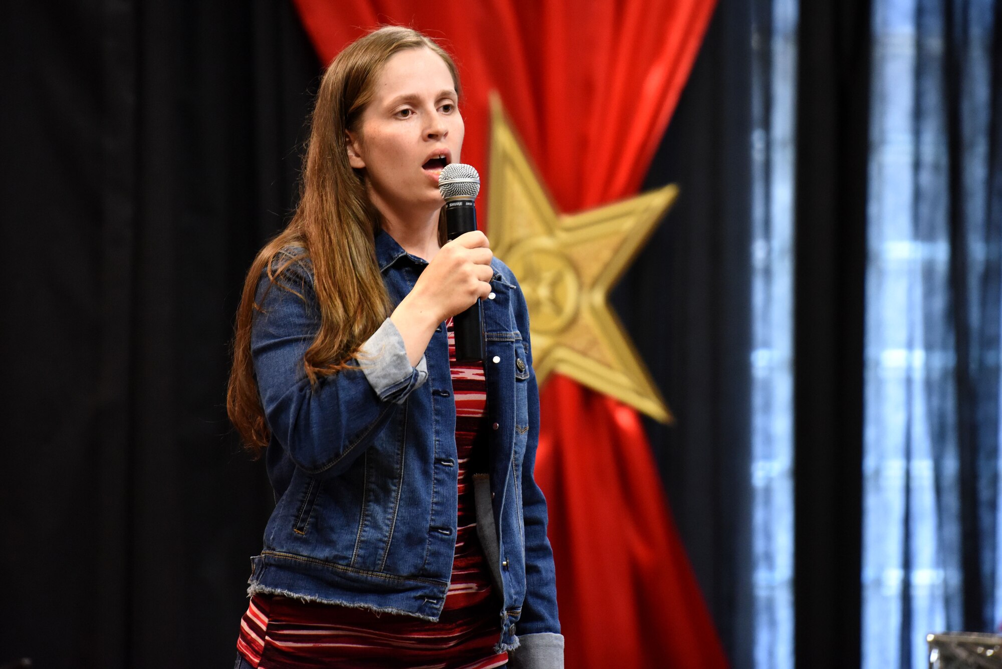 Goodfellow’s Got Talent Show participant, Sariah Berglund sings ‘America the Beautiful’ during the competition at the Event Center on Goodfellow Air Force Base, Texas, June 8, 2018. Berglund placed second in the competition this year. (U.S. Air Force photo by Airman 1st Class Seraiah Hines/Released)