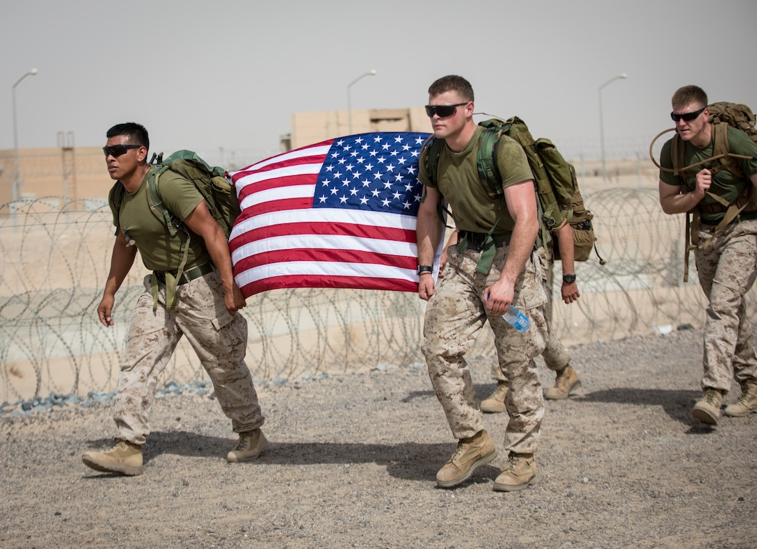 UNDISCLOSED LOCATON, MIDDLE EAST – U.S. Marines with Special Purpose Marine Air-Ground Task Force, Crisis Response-Central Command carry the American flag during A Ruck to Remember 10k Hike June 9, 2018. The hike honored fallen servicemen and women.