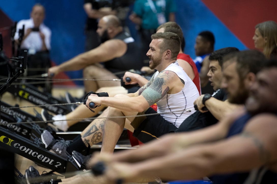 An Australian soldier takes part in an indoor rowing competition.