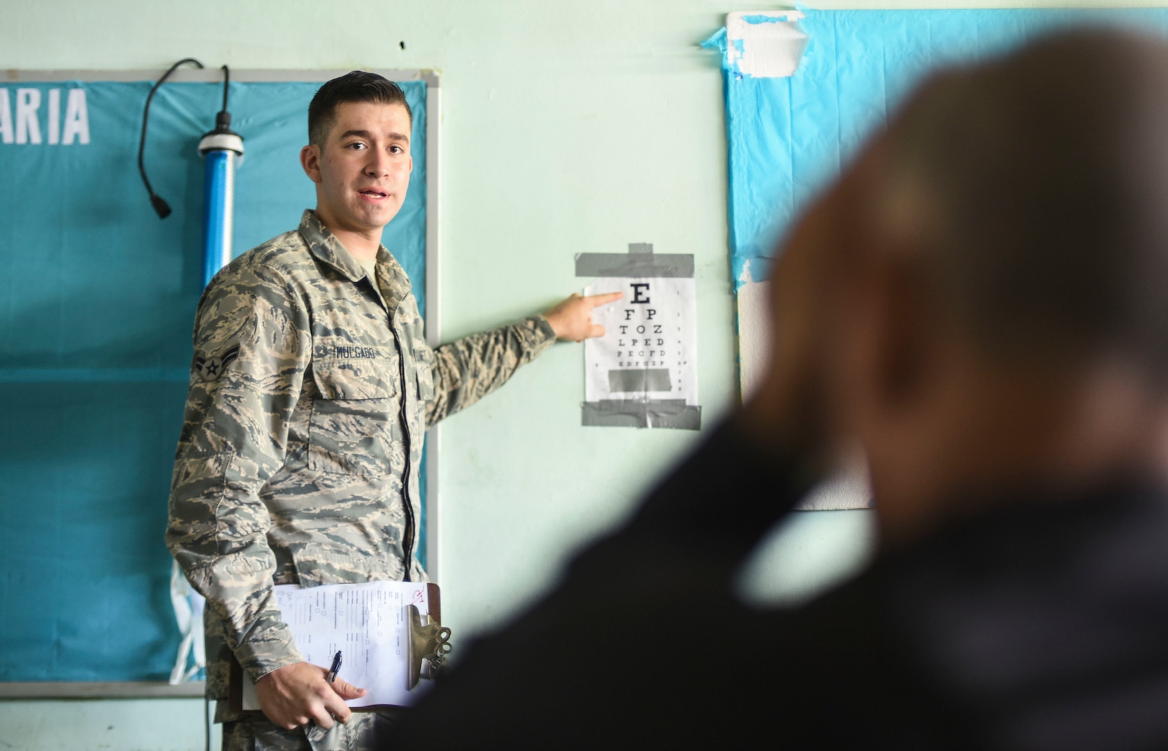 An Air Force doctor checks a patient’s eye sight.