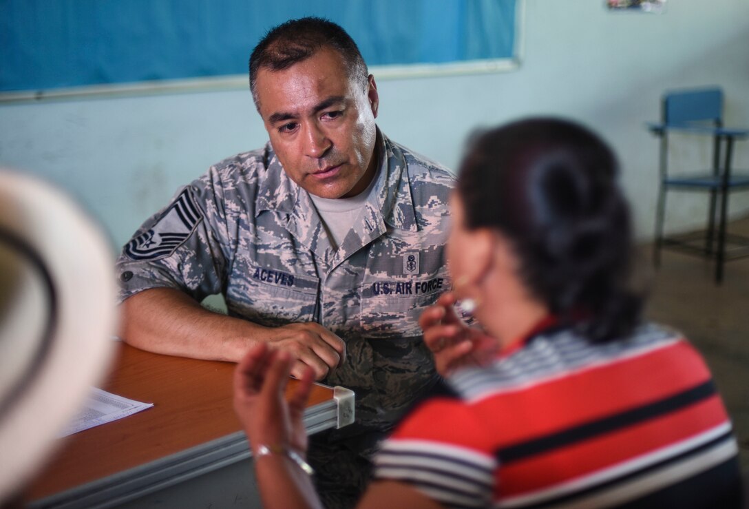 A U.S. Air Force officer speaks with a woman
