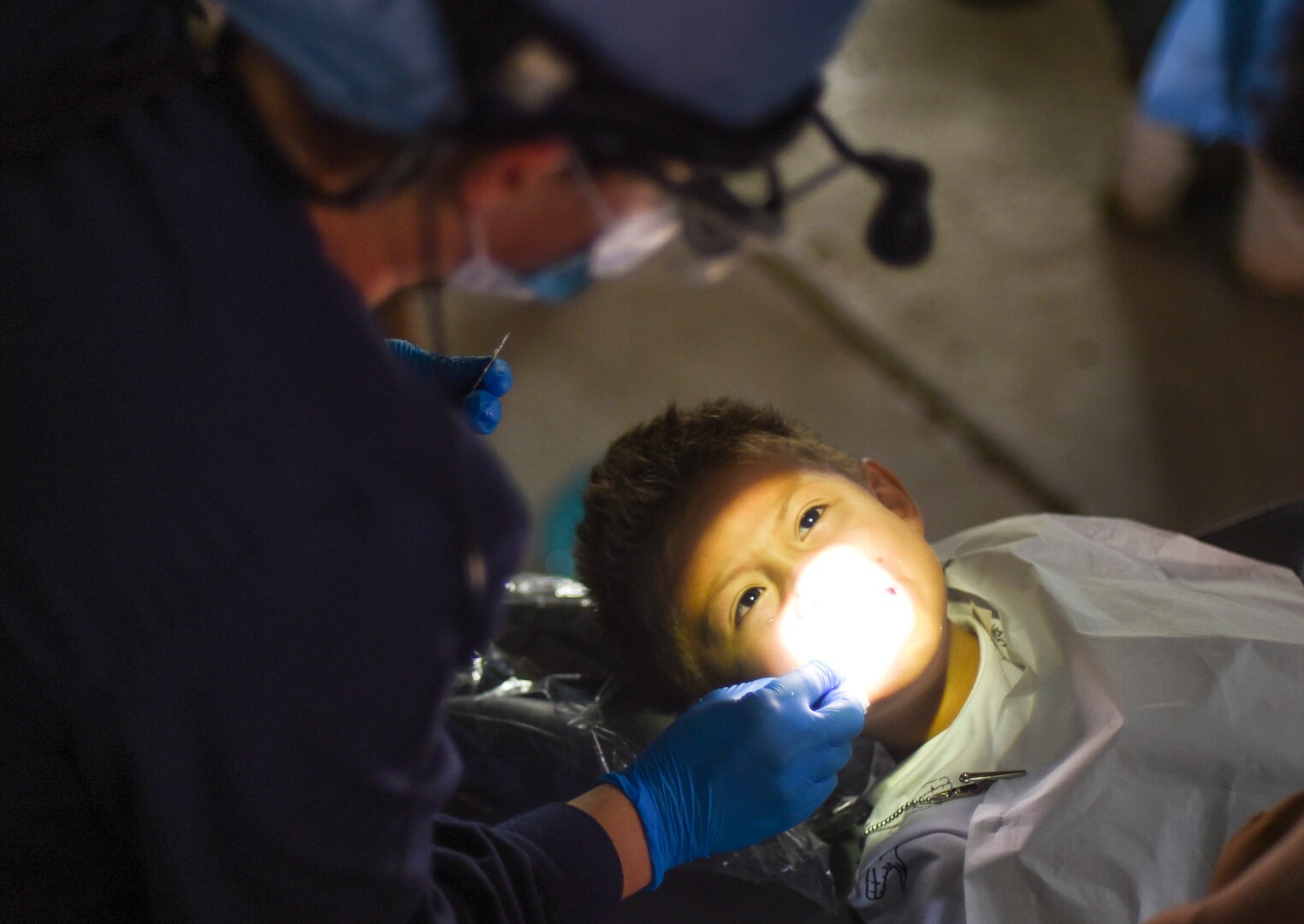 An Air Force dentist treats a patient