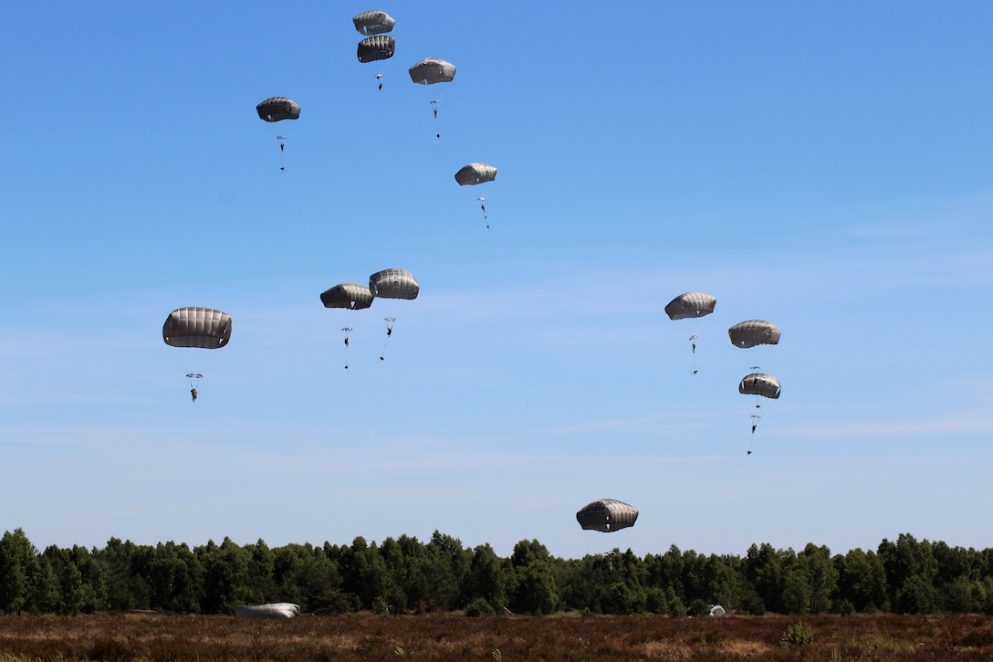Soldiers parachute into Eagle drop zone after jumping from a C-17 Globemaster III aircraft.