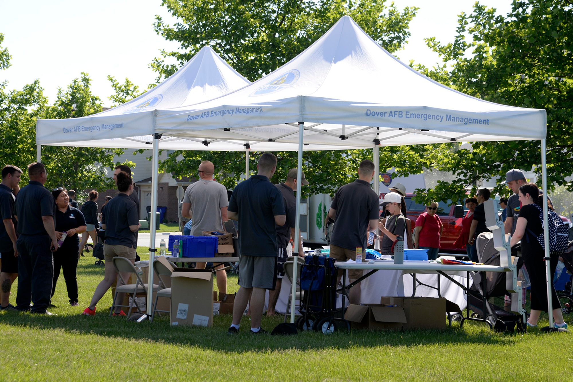 436th Civil Engineer Squadron emergency management flight Airmen distribute disaster preparedness items to families May 24, 2018, during a hurricane block party in base housing on Dover Air Force Base, Del. Each year, on-base emergency management agencies and off-base vendors come together during the Memorial Day weekend to remind members of Team Dover to plan ahead and be prepared before they find themselves in an emergency situation. (U.S. Air Force photo/Tech. Sgt. Matt Davis)