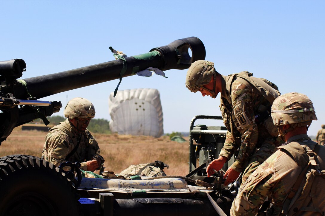 Soldiers secure an M119 105 mm howitzer at Eagle drop zone.