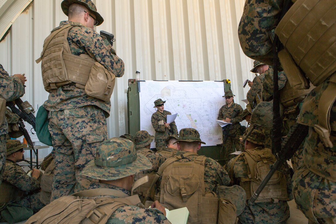 1st. Lt. Melissa Cooling (center), recovery officer in charge with Combat Logistics Battalion 25, Combat Logistics Regiment 45, 4th Marine Logistics Group, briefs her Marines before beginning a motorized operations training exercise, at Marine Corps Air Ground Combat Center Twentynine Palms, California, June 9, 2018. During Integrated Training Exercise 4-18, CLB-25 Marines took part in MOT to further their experience with crew-served weapons employment, improvised explosive device immediate action drills and establishment of a Helicopter Landing Zone.