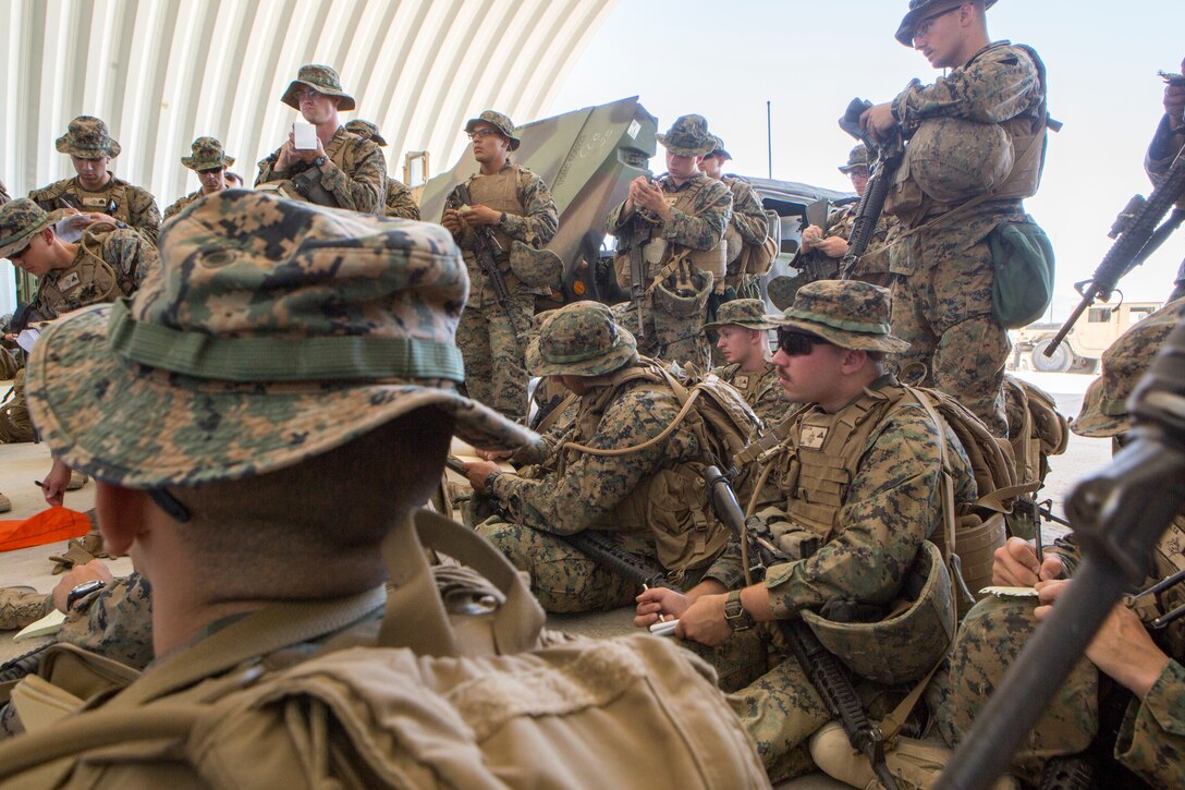 Marines with Combat Logistics Battalion 25, Combat Logistics Regiment 45, 4th Marine Logistics Group, listen to 1st Lt. Melissa Cooling, recovery officer in charge with CLB-25, CLB-45, 4th MLG, give an operations order before execution of a motorized operations training exercise, at Marine Corps Air Ground Combat Center Twentynine Palms, California, June 9, 2018. During Integrated Training Exercise 4-18, CLB-25 Marines took part in MOT to further their experience with crew-served weapons employment, improvised explosive device immediate action drills and establishment of a Helicopter Landing Zone.