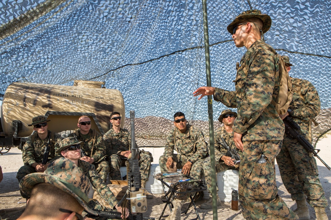 Petty Officer 2nd Class Israel Mejias, a corpsman with Combat Logistics Battalion 25, Combat Logistics Regiment 45, 4th Marine Logistics Group, gives a lesson on combat first aid to Reserve Marines with CLB-25, at Marine Corps Air Ground Combat Center Twentynine Palms, California, June 9, 2018. During Integrated Training Exercise 4-18, CLB-25 Marines took part in MOT to further their experience with crew-served weapons employment, improvised explosive device immediate action drills and establishment of a Helicopter Landing Zone.