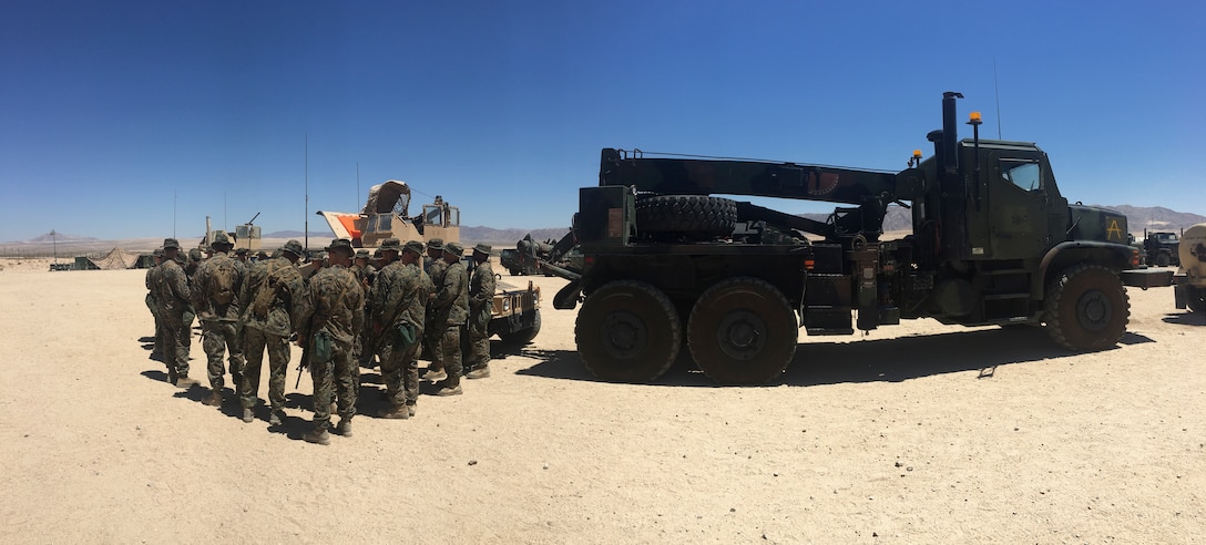Marines with Combat Logistics Battalion 25, Combat Logistics Regiment 45, 4th Marine Logistics Group, gather for a brief prior to embarking on a convoy to Range 113, aboard Marine Corps Air Ground Combat Center Twentynine Palms, California, June 9, 2018. During Integrated Training Exercise 4-18, CLB-25 Marines took part in MOT to further their experience with crew-served weapons employment, improvised explosive device immediate action drills and establishment of a Helicopter Landing Zone.