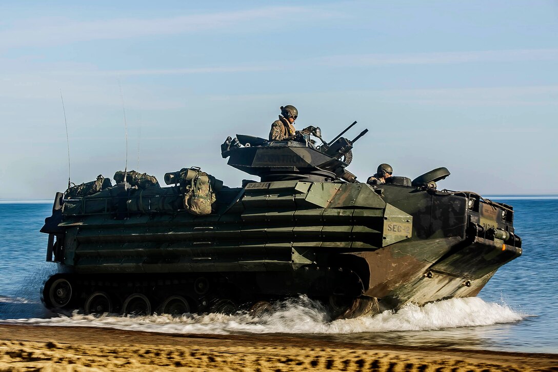 Marines drive an amphibious assault vehicle to a staging area.