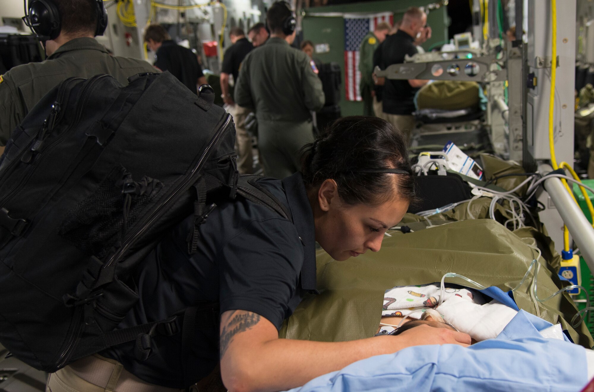 U.S. Army Capt. Argelia Felix-Camacho, registered nurse, San Antonio Military Medical Center Burn Team, consoles a patient during an aeromedical evacuation mission from Guatemala to Galveston, Texas, June 6, 2018. A U.S. Air Force C-17 Globemaster III from the Mississippi Air National Guard's 172nd Airlift Wing transported six injured children and their guardians to Galveston, Texas, for medical treatment at Shriners Hospital for Children. A joint medical team from the Mississippi Air National Guard's 183rd Air Evacuation Squadron and Joint Base San Antonio, Texas, provided en route medical treatment during the flight (U.S. Air Force photo by Master Sgt. Keyonna Fennell)