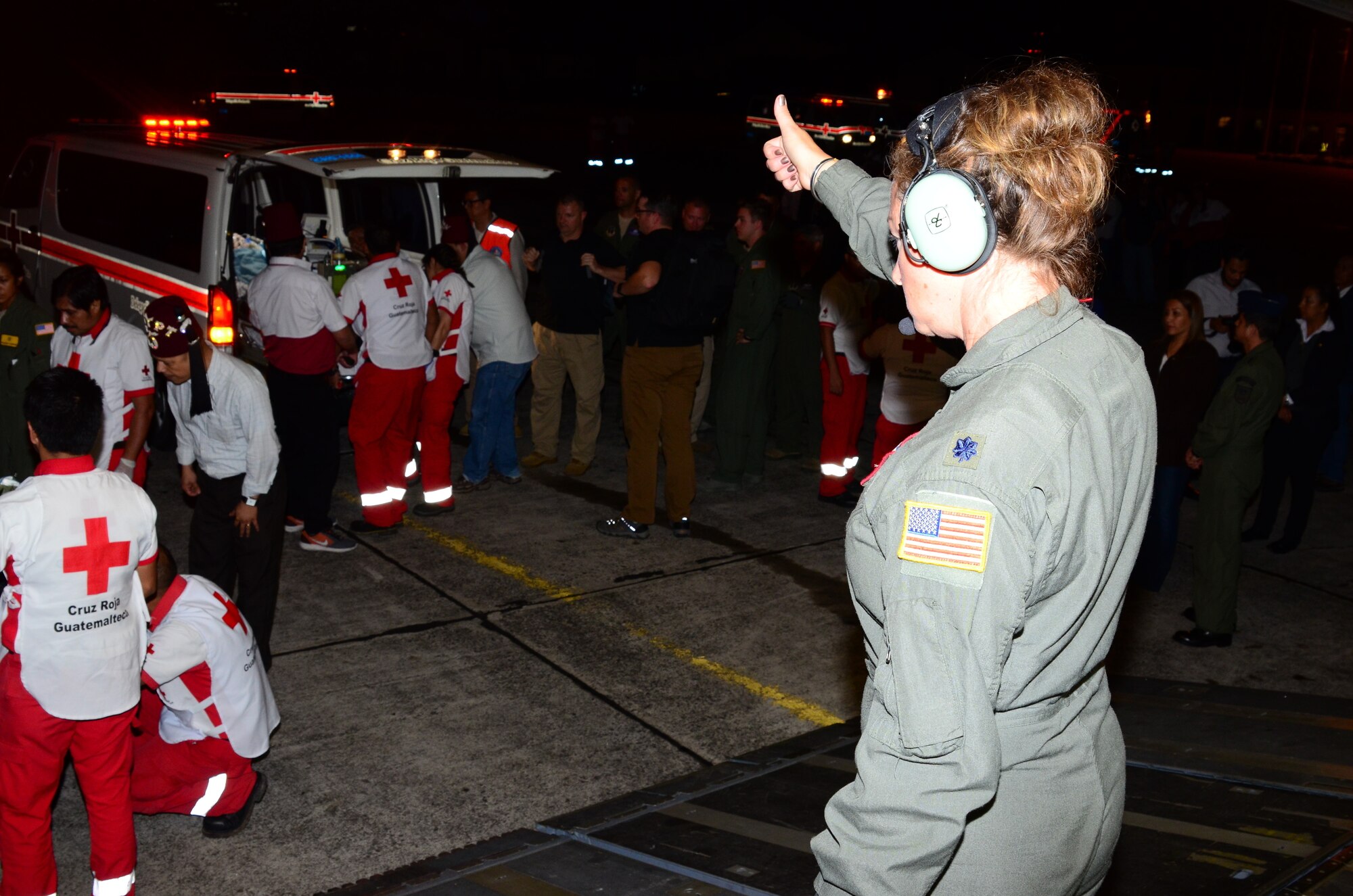 U.S. Air Force Lt. Col. Teri Dawn Neely, a registered nurse with the 183rd Air Evacuation Squadron, Mississippi Air National Guard, clears a Guatemalan ambulance crew to load another patient on a Mississippi ANG's 172nd Airlift Wing C-17 Globemaster III in Guatemala, June 6, 2018. (U.S. Air National Guard photo by Tech. Sgt. Edward Staton)