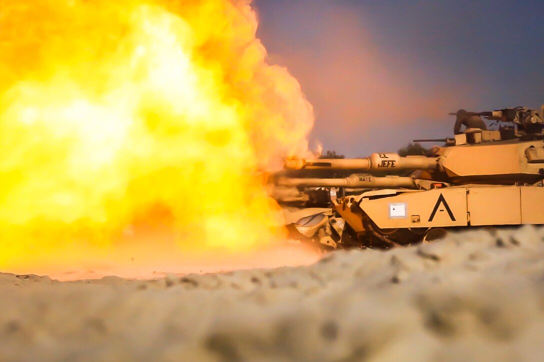 Marine Corps M1A1 Abrams tanks engage targets during live-fire training.