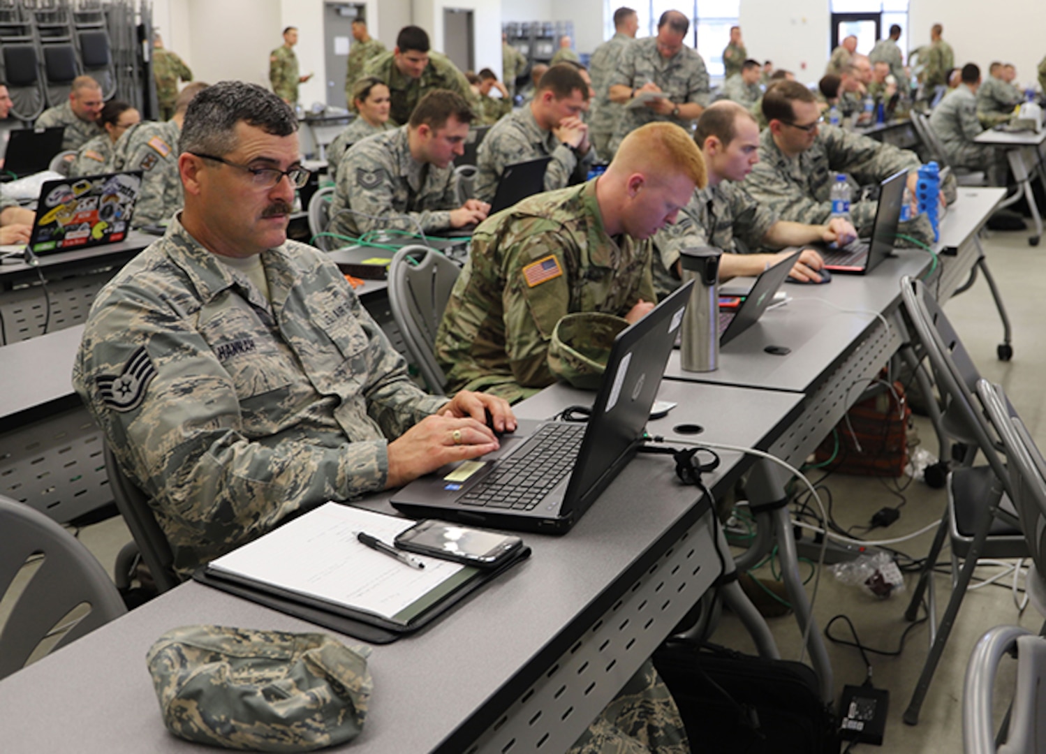 Soldiers and Airmen training with the Cyber Yankee 2018 exercise prepare counter cyber-attacks to scenarios given them during the exercise at Joint Base Cape Cod, Mass.