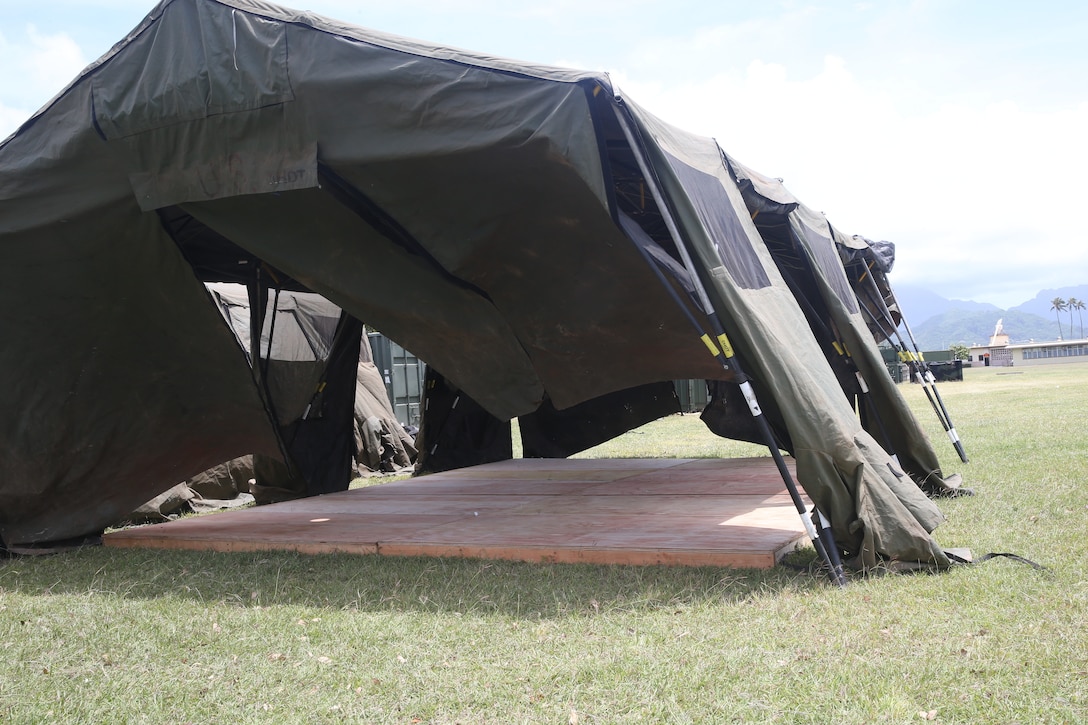 U.S. Marines with 1st Battalion, 3rd Marine Regiment, set up tents at Landing Zone 216 aboard Marine Corps Base Hawaii in preparation of the Rim of the Pacific Exercise (RIMPAC) 2018, June 6th, 2018. RIMPAC is the world's largest international maritime exercise taking place every two years, in and around the Hawaiian Islands and Southern California. This year’s exercise will be its twenty sixth iteration, focusing on the theme of “Capable, Adaptive, Partners”. (U.S. Marine Corps Photo by Sgt. Alex Kouns)