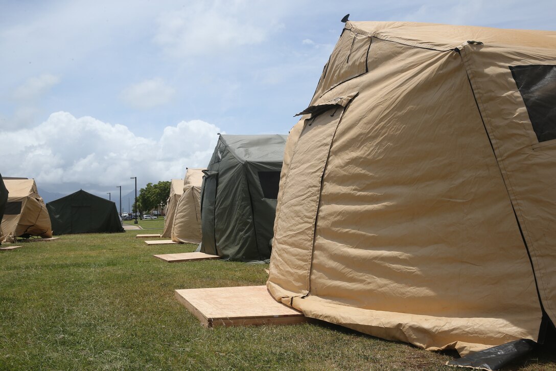 U.S. Marines with 1st Battalion, 3rd Marine Regiment, set up tents at Landing Zone 216 aboard Marine Corps Base Hawaii in preparation of the Rim of the Pacific Exercise (RIMPAC) 2018, June 6th, 2018. RIMPAC is the world's largest international maritime exercise taking place every two years, in and around the Hawaiian Islands and Southern California. This year’s exercise will be its twenty sixth iteration, focusing on the theme of “Capable, Adaptive, Partners”. (U.S. Marine Corps Photo by Sgt. Alex Kouns)