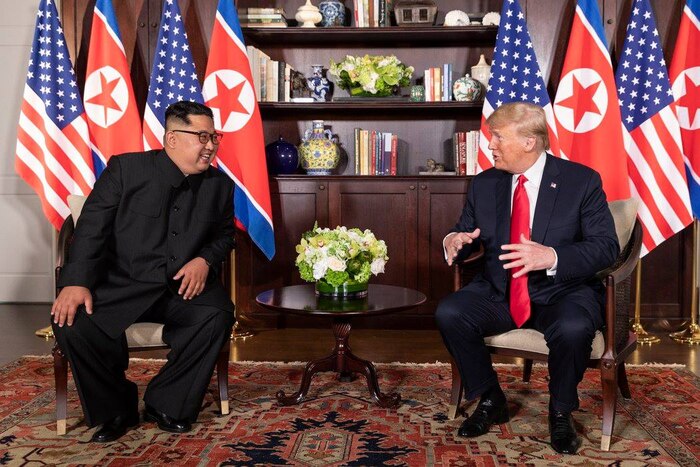 President Donald J. Trump and the North Korean leader Kim Jong Un sit together.