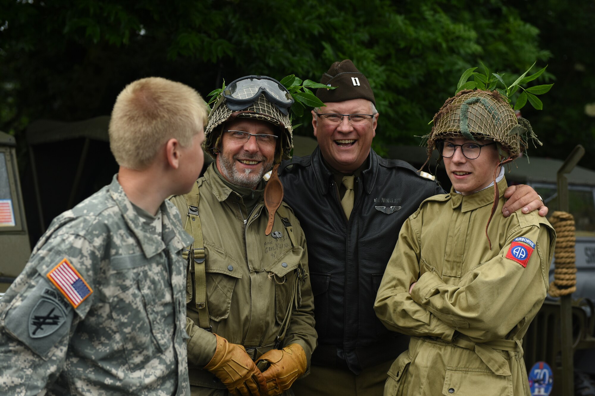 Reenactors stand outside in the run during a ceremony.