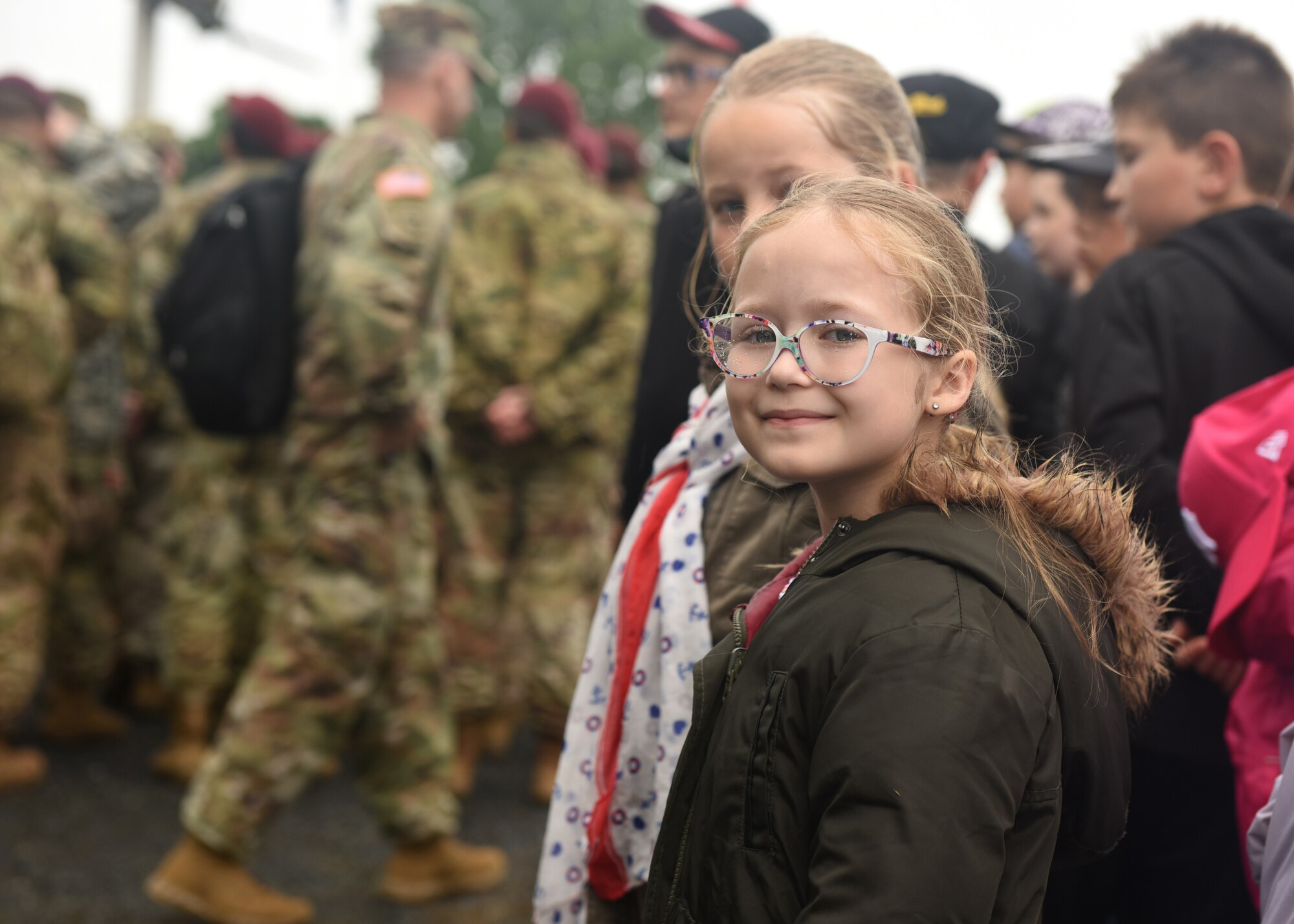 A person observes military members during a celebration.