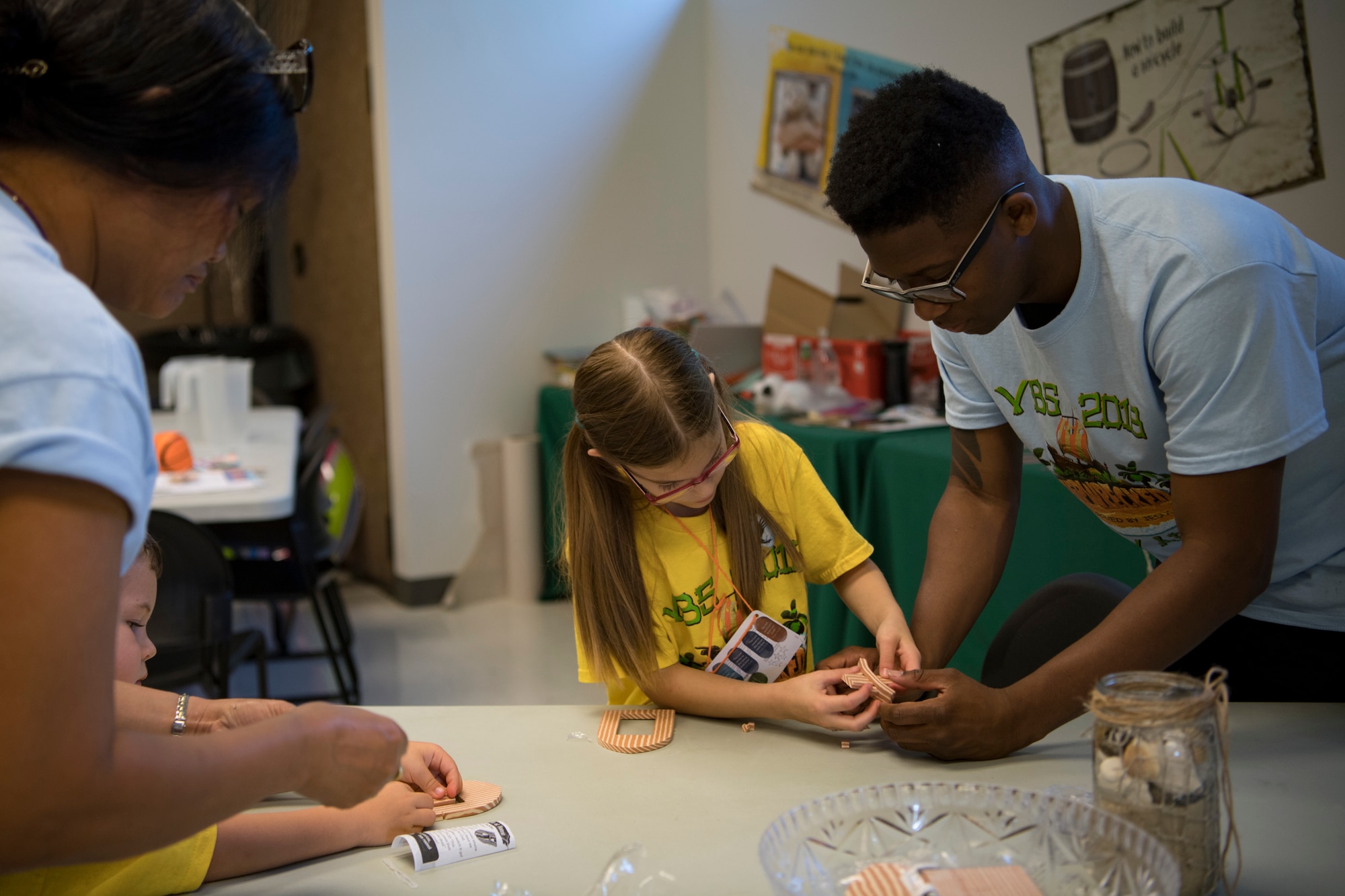 Volunteers assist children with arts and crafts projects during the base chapel’s Vacation Bible School, June 8, 2018, at Moody Air Force Base, Ga.  VBS is designed to assist children in building resiliency to the stressors many military families face. More than 95 children and 65 volunteers attended this year’s VBS. (U.S. Air Force photo by Senior Airman Daniel Snider)