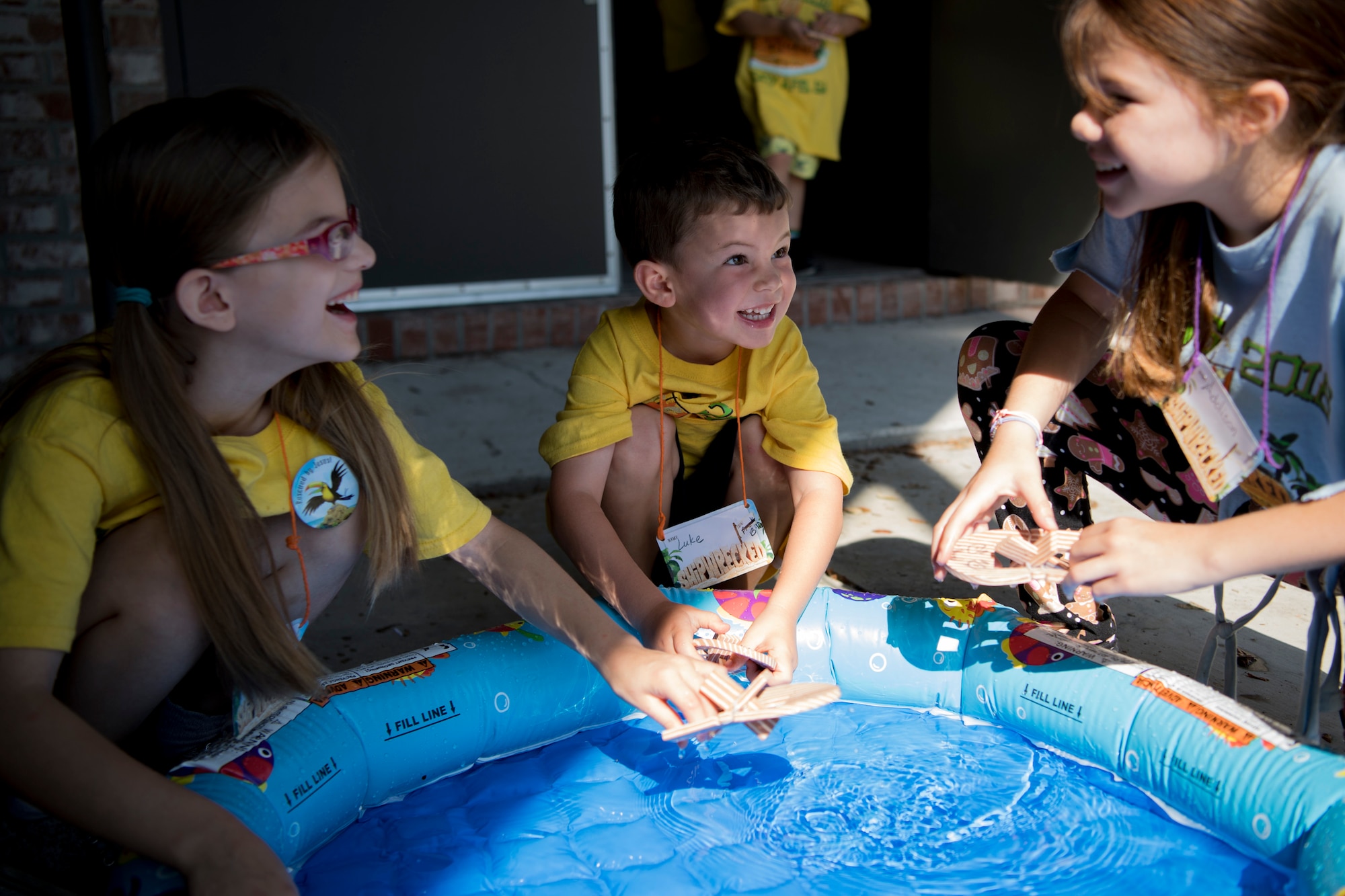 Children operate their arts and crafts projects in a small pool of water during the base chapel’s Vacation Bible School, June 8, 2018, at Moody Air Force Base, Ga. VBS is designed to assist children in building resiliency to the stressors many military families face. More than 95 children and 65 volunteers attended this year’s VBS. (U.S. Air Force photo by Senior Airman Daniel Snider)