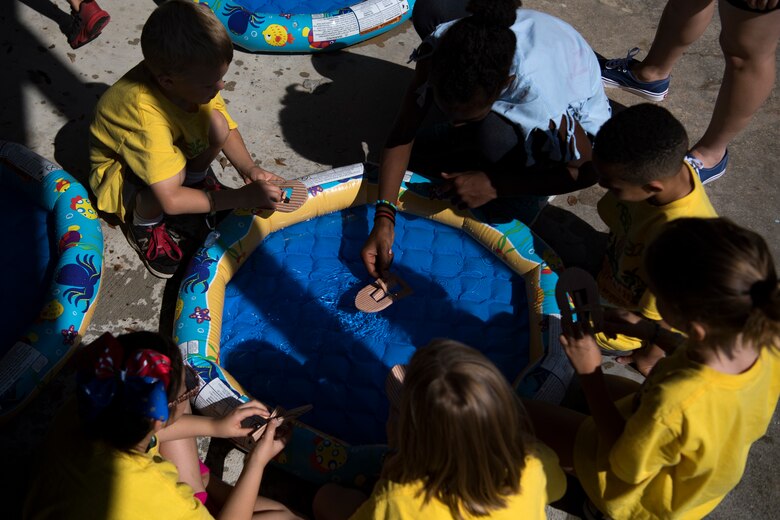 Children and volunteers operate their arts and crafts projects in a small pool of water during the base chapel’s Vacation Bible School, June 8, 2018, at Moody Air Force Base, Ga. VBS is designed to assist children in building resiliency to the stressors many military families face. More than 95 children and 65 volunteers attended this year’s VBS. (U.S. Air Force photo by Senior Airman Daniel Snider)