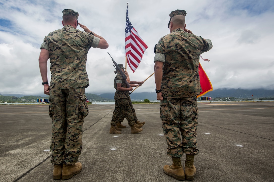 U.S. Marine Corps Lt. Col. Kenneth Phelps and Lt. Col. Peter Ban salute the colors during a change of command ceremony, Marine Corps Air Station Kaneohe Bay, Marine Corps Base Hawaii, June 7, 2018. Lt. Col. Kenneth Phelps retired and relinquished command of Marine Unmanned Aerial Vehicle Squadron 3 to Lt. Col. Peter Ban. (U.S. Marine Corps photo by Lance Cpl. Matthew Kirk)