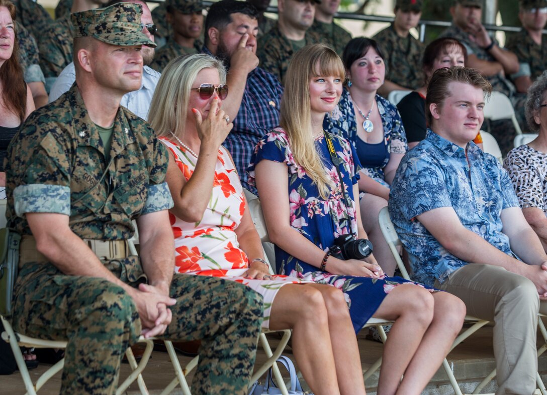 U.S. Marine Corps Lt. Col. Paul Goguen and his family watch Lt. Col. Bolivar Pluas speak to service members and families during a change of command ceremony, Marine Corps Base Hawaii, June 8, 2018. Pluas relinquished command of Combat Logistics Battalion 3 to Goguen. (U.S. Marine Corps photo by Lance Cpl. Matthew Kirk)