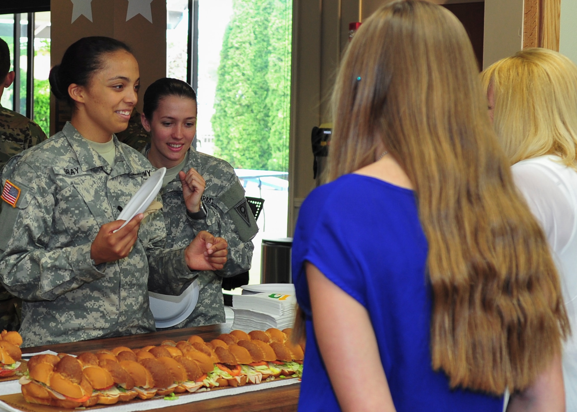 USO volunteers serve food to two soldiers from the Ohio National Guard’s 838th Military Police Company at Youngstown Air Reserve Station USO lounge June 8.